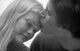 Close-up poster print of a young man kissing a young woman's forehead.