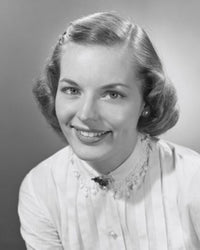 Portrait of a young woman smiling in a studio shot poster print