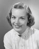 Portrait of a young woman smiling in a studio shot poster print