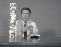 Studio shot of a man thoughtfully looking at cigarettes poster print.
