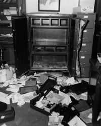 Documents scattered in front of an open safe poster print