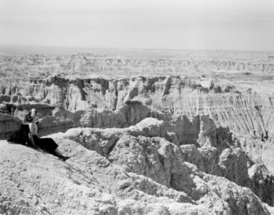 Female tourist admiring the landscape of South Dakota's Badlands poster print.