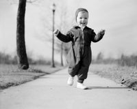 Exhilarated baby girl on footpath poster print capturing joy and innocence.