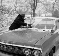 Men Cleaning Car from Snow Poster Print showcasing winter scene.