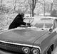 Men Cleaning Car from Snow Poster Print showcasing winter scene.
