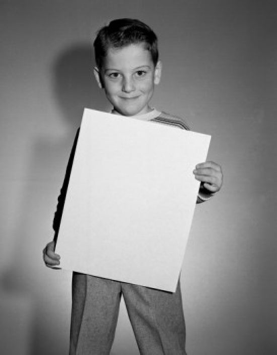 Portrait of boy holding document poster print showcasing youth and curiosity.