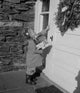 Poster of a girl carrying Christmas gifts and ringing a doorbell, festive holiday art.