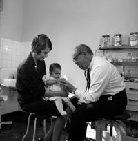 Mother and baby girl in doctor's office poster print.