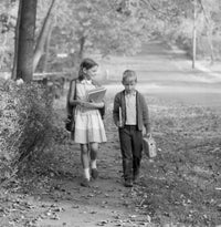 Boy and girl walking to school poster print