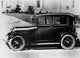 1929 Vintage Car Poster Print showcasing a classic automobile in front of a building.