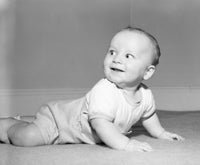 Adorable baby boy crawling and smiling poster print.
