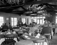 People Sitting in Restaurant Poster Print showcasing a lively dining atmosphere.