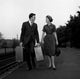 Young couple carrying suitcases at rail station poster print