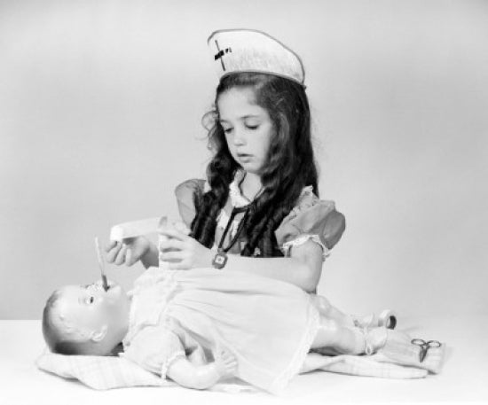 Poster print of a girl playing nurse and taking care of her doll.