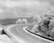 Winding Road in Mountain Area Poster Print showcasing a scenic landscape.