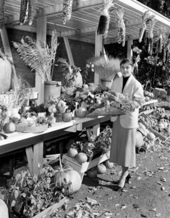 Young woman standing in front of market stalls at a farmer's market poster print.