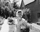 Mid adult woman wearing bonnet in summer garden poster print