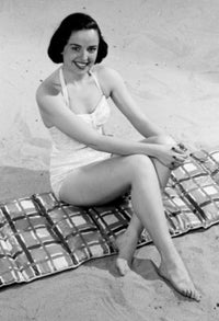 Young Woman Sitting on Beach Poster Print - serene beach scene