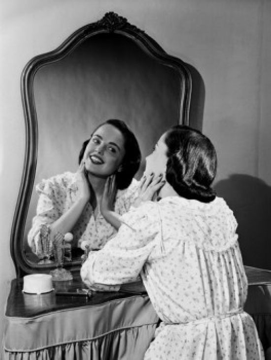 Young Woman Looking at Mirror Poster Print showcasing introspection and beauty.