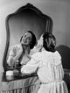 Young Woman Looking at Mirror Poster Print showcasing introspection and beauty.