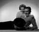 Young couple lying on the floor looking at records poster print