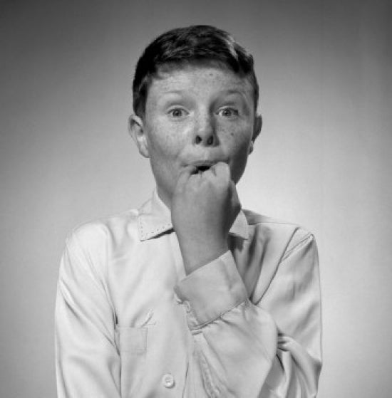 Portrait of a freckled boy holding his hand in his mouth poster print.