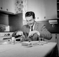 Portrait of a man dining in a kitchen poster print