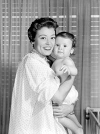 Portrait of mother embracing baby in bedroom, poster print.