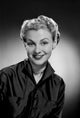 Portrait of a young woman smiling, studio shot poster print