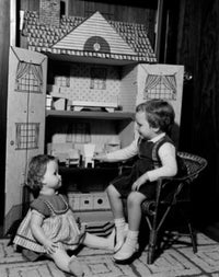 Girl playing with dollhouse poster print for kids' rooms