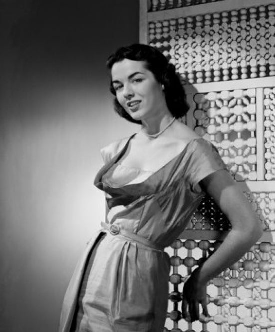 Portrait of a young woman leaning against a screen partition poster print.