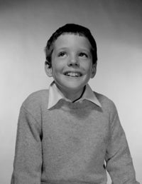 Portrait of Smiling Boy Poster Print showcasing a joyful expression.