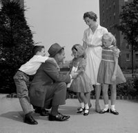 Children Embracing Father Outdoors Poster Print showcasing family love and warmth.
