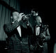 Two Men Playing on Stage Poster Print showcasing vibrant live performance art.