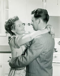 Couple Embracing in Home Poster Print depicting love and warmth.