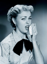 Studio Portrait of Young Woman Sneezing Poster Print showing a young woman in a candid moment.