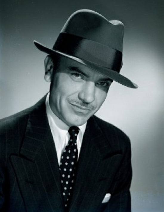 Studio portrait of a businessman wearing a hat, perfect for office decor.