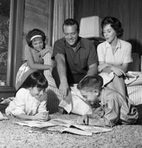 Parents Watching Children Read on Carpet Poster Print