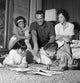 Parents Watching Children Read on Carpet Poster Print