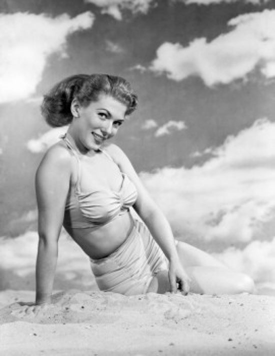 Portrait of a young woman sitting on the beach poster print