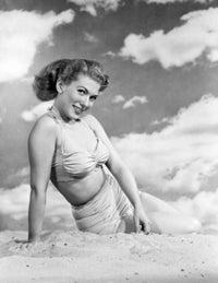 Portrait of a young woman sitting on the beach poster print