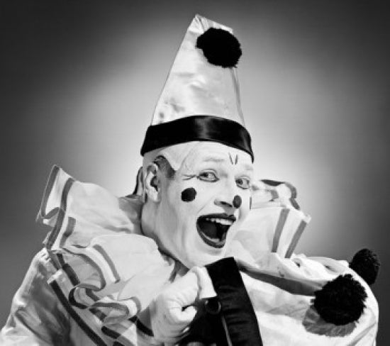 Studio portrait of a laughing clown poster print
