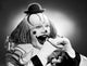 Studio shot of clown eating sandwich poster print