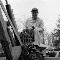 Man Driving Tractor Poster Print showcasing rural life.
