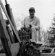 Man Driving Tractor Poster Print showcasing rural life.