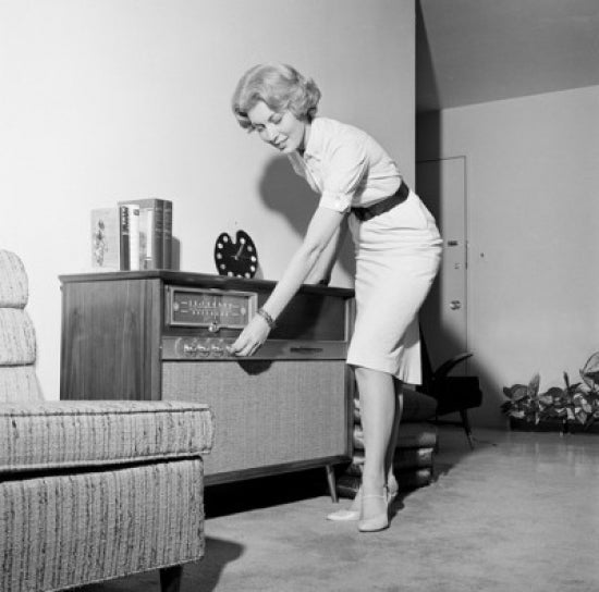 Woman Listening to Radio in Living Room Poster Print