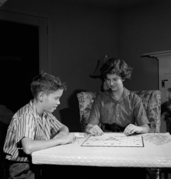 Mother and son playing Scrabble at home poster print.