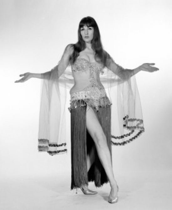 Portrait of a young woman wearing a belly dance outfit, colorful and dynamic.
