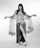 Portrait of a young woman wearing a belly dance outfit, colorful and dynamic.