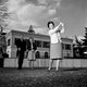 Mature woman playing golf while spectators watch - Poster Print